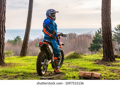 Man Riding A Motocross In A Protective Suit