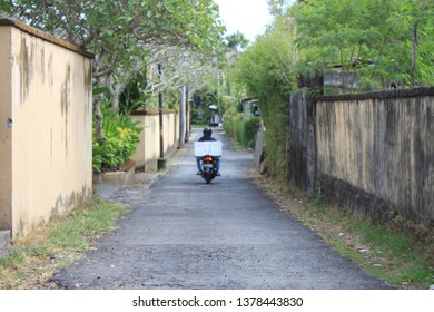 A Man Riding Motorcycle Away