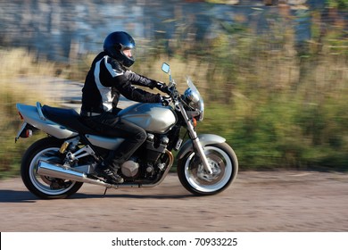 Man Riding A Motorcycle On The Road