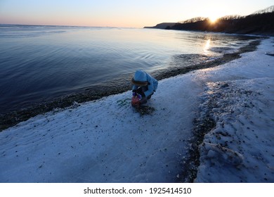 A Man Riding A Snow Board On A Body Of Water