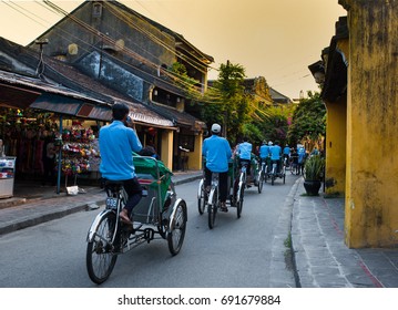 Man Riding A Traditional Cycle In Hoi An.Hoian, A Major Tourist Destination In Central Vietnam