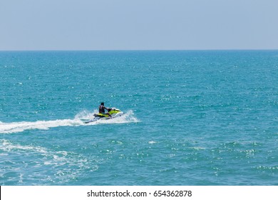 Man Riding A Water Scooter At Sea