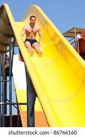 Man Riding A Water Slide