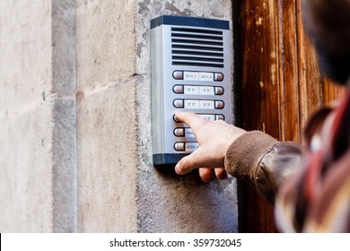 Man Ringing The Doorbell On The Street