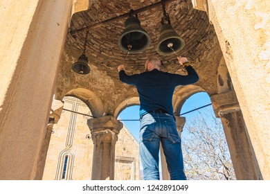 Man Ringing Old Church Bells