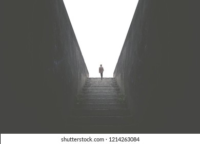 Man Rising Dark Stair To Reach The Light