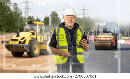 Man road construction engineer. Worker with phone near asphalt paving machines. Man supervisor road construction workers. Asphalt rollers behind man standing with phone. Road engineer in yellow vest.