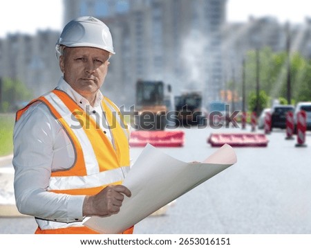 Man road infrastructure architect. Builder with papers supervises asphalt laying. Confident man architect looking at camera. Director of road building company. Road transport infrastructure architect
