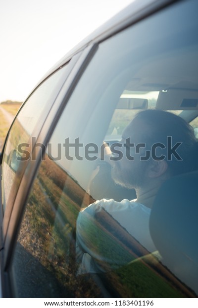 man in road trip in\
car