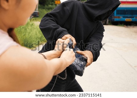 Man robbed woman, Thief stealing in public Foto stock © 