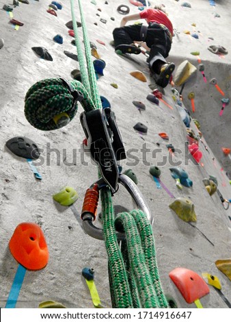 A man rockclimbs on a wall