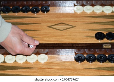 Man Rolling The Backgammon Dice