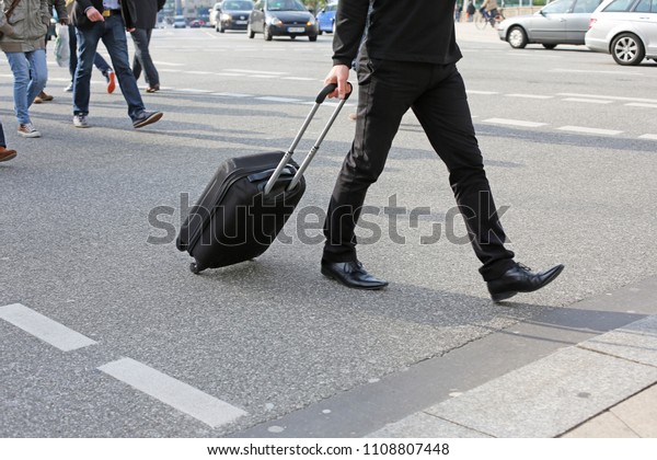 man with rolling\
case
