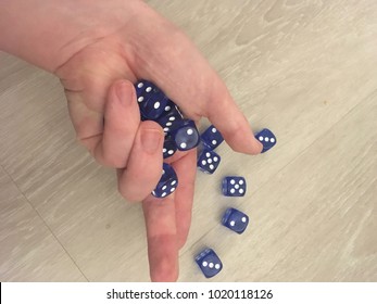 Man Rolling Dice Onto Floor In Game Of Chance And Risk