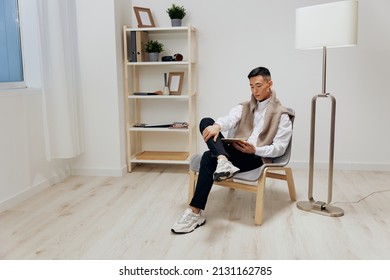 man in the room with the tablet in the chair rest technologies - Powered by Shutterstock