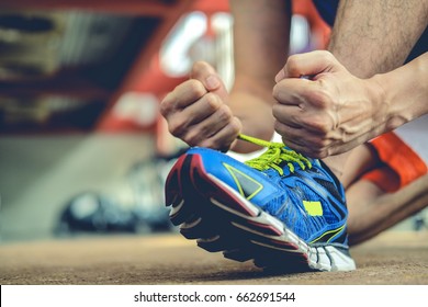 man Rope tie shoe run in gym - Powered by Shutterstock