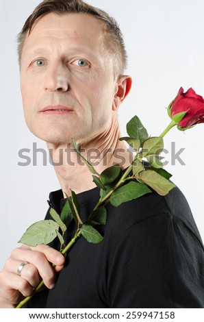 Similar – Man in tails with bouquet and top hat looks into camera