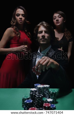 Man at roulette table surrounded by beautiful women