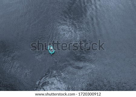 Similar – Aerial view of small boat in sea