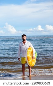 Man With Rubber Ring On The Beach