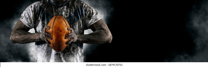 Man rugby player holds ball. Sports banner. Horizontal copy space background - Powered by Shutterstock