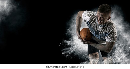 Man rugby player holds ball. Sports banner. Horizontal copy space background - Powered by Shutterstock