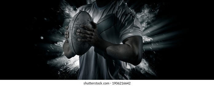 Man rugby player holds ball. Sports banner. Horizontal copy space background - Powered by Shutterstock