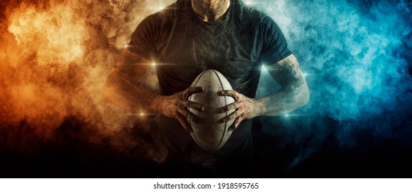 Man rugby player holds ball on dark background. Sports banner. Horizontal copy space background - Powered by Shutterstock