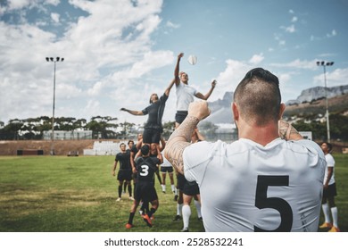 Man, rugby and team with ball throw for game, match or competition on outdoor grass field or pitch. Male person, players and pass with scrum or lineout for play, tournament or sports at stadium - Powered by Shutterstock