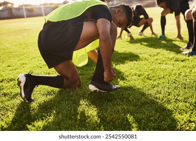 Man, rugby or tying lace with grass field for training preparation, game or outdoor match. Active, male person or young football player tie shoes or getting ready for sport, exercise or team practice - Powered by Shutterstock