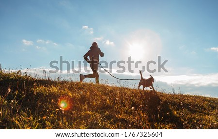 Man runing with his beagle dog at sunny morning. Healthy lifestyle and Canicross exercises jogging concept image. Stock photo © 