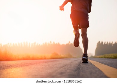man runner athlete on the road to healthy, Young people running exercise on street.