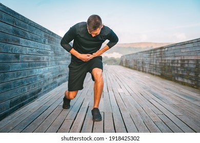 Man Runner Having Stomach Side Cramps Or Stitch During Training. Athlete Suffering From Pain In His Side. Side Pain After Jogging Or Running.