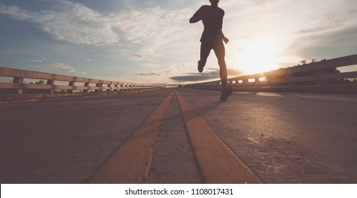 The Man With Runner On The Street Be Running For Exercise.