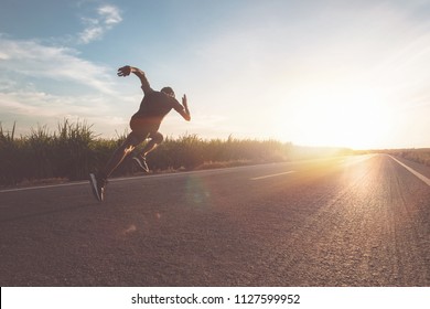 The man with runner on the street be running for exercise. - Shutterstock ID 1127599952