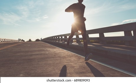 The man with runner on the street be running for exercise. - Shutterstock ID 689809093