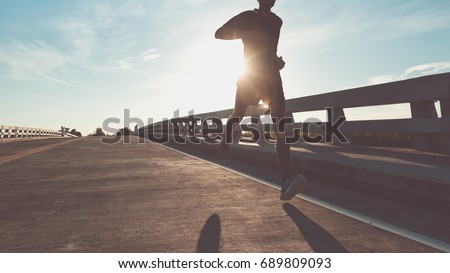The man with runner on the street be running for exercise.