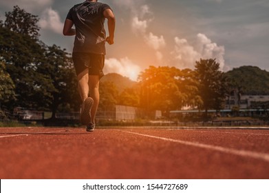 Man runner ready for sports exercise in the sunset on the race track. - Shutterstock ID 1544727689
