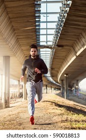 Man Runner Under Bridge In The City