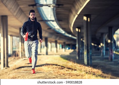 Man Runner Under Bridge In The City