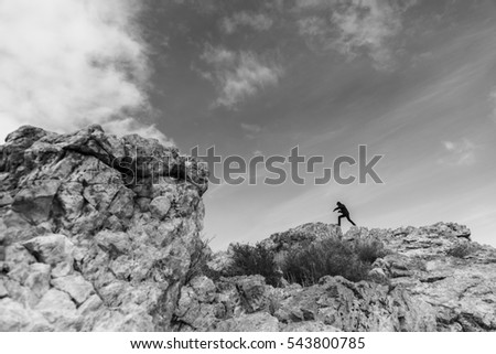 Similar – Beautiful young woman thinking and sitting on the rocks outdoors on the countryside