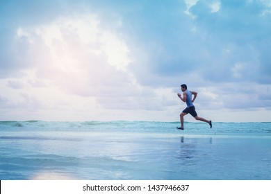 Man running athletes at the beach with sunset background. - Powered by Shutterstock