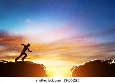 Man Running Fast To Jump Over Precipice Between Two Mountains. Concepts Of Determination, Business, Challenge, Success, Risk Etc.