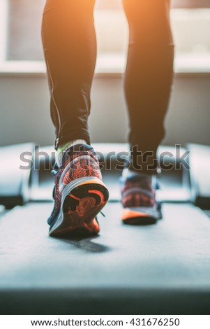 Man running in a gym on a treadmill
