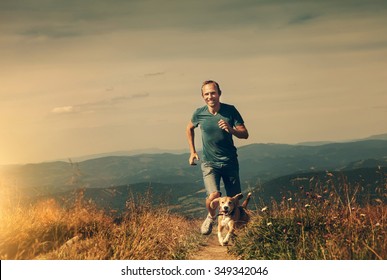 Man running with his dog on the mountain tableland