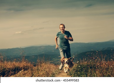 Man running with his dog on the mountain tableland