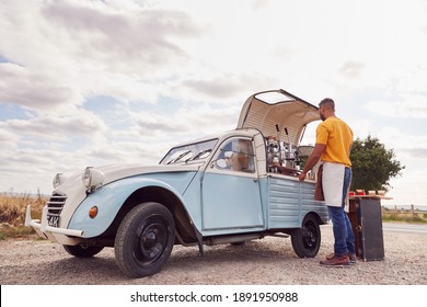 Man Running Independent Mobile Coffee Shop Preparing Drink Standing Outdoors Next To Van - Powered by Shutterstock