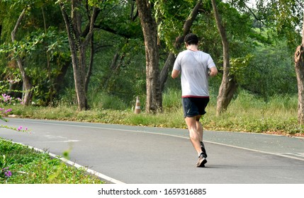 The Man Is Running In The Jatujak Garden,Bangkok,Thailand.