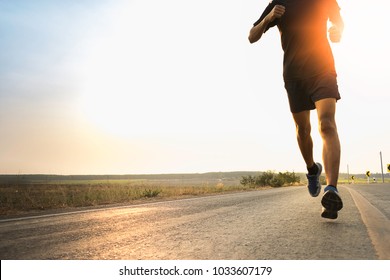 Man running jogging on bridge road. Health activities, Exercise by runner. - Shutterstock ID 1033607179