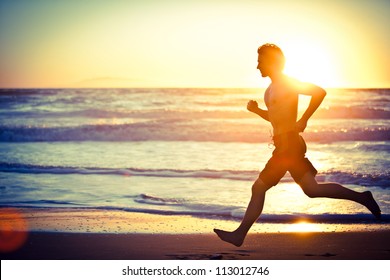 Man running on the beach at sunset - female version in portfolio
